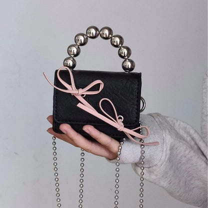 Bolso de mano mini con cadena y lazo texturizado