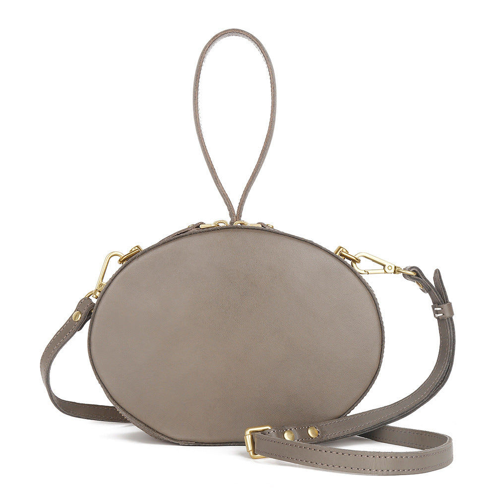 Sac à bandoulière en cuir de vachette de première couche pour femme, simple, rond, à porter à la main, style rétro