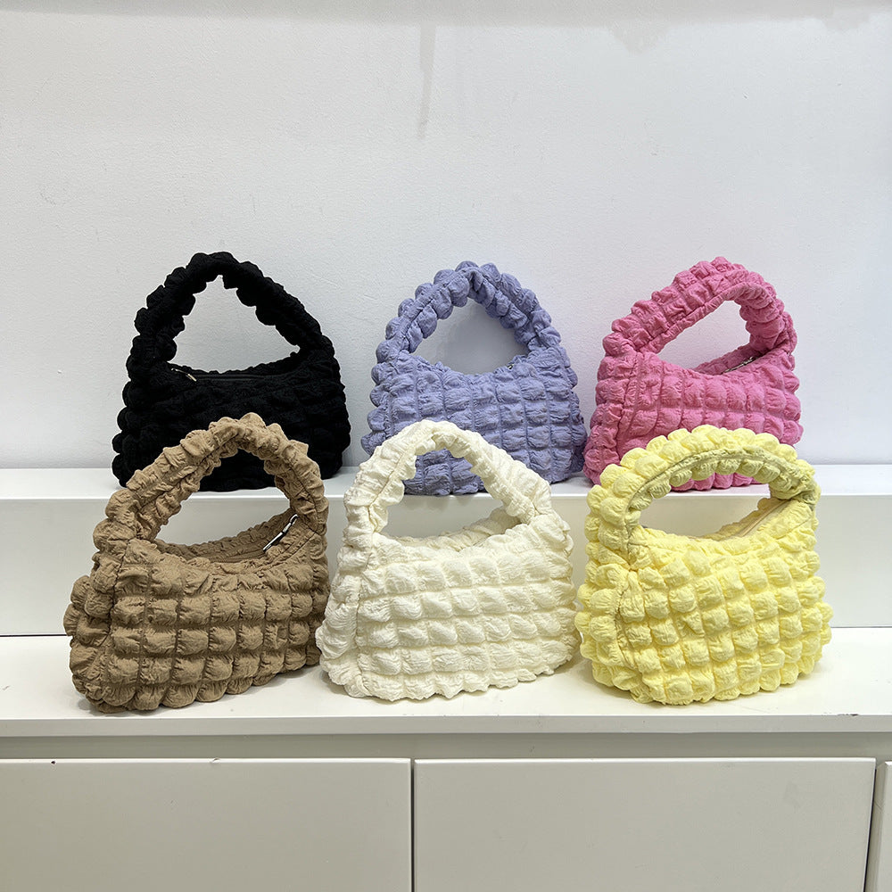 Bolso de mano estilo occidental con pliegues suaves y burbujas